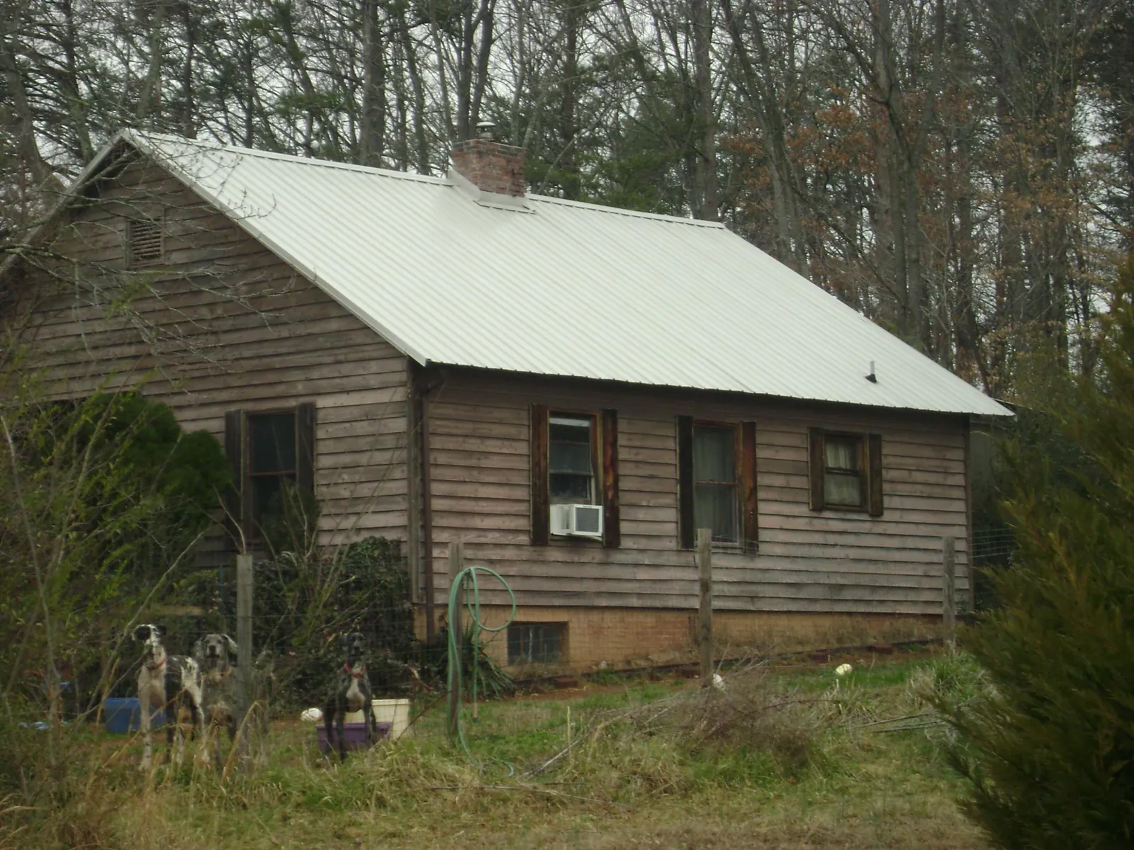 White metal roof on an old wood sided farmhouse, from a Metal Roof Installation job in Suffield